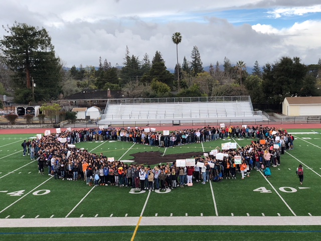 Students forming a large heart on the football field